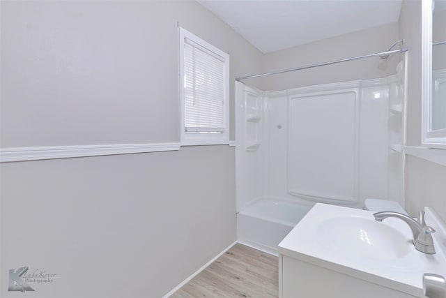 bathroom with vanity, shower / tub combination, and hardwood / wood-style floors