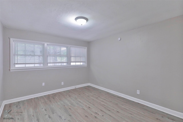 spare room featuring light hardwood / wood-style floors