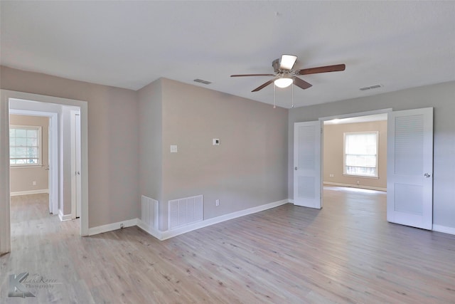 unfurnished room with ceiling fan and light hardwood / wood-style flooring