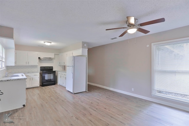 kitchen featuring light hardwood / wood-style flooring, black range with electric cooktop, sink, white cabinets, and white fridge