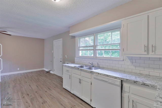 kitchen featuring light hardwood / wood-style flooring, white dishwasher, sink, white cabinetry, and tasteful backsplash