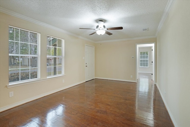 spare room featuring dark wood-type flooring, ceiling fan, a textured ceiling, and ornamental molding