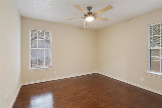 empty room featuring ceiling fan, a textured ceiling, and dark hardwood / wood-style floors