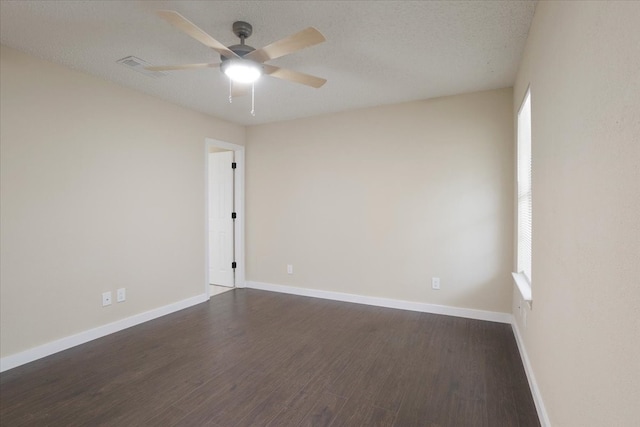 spare room featuring ceiling fan, a textured ceiling, and dark hardwood / wood-style floors