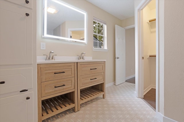 bathroom featuring vanity and a textured ceiling