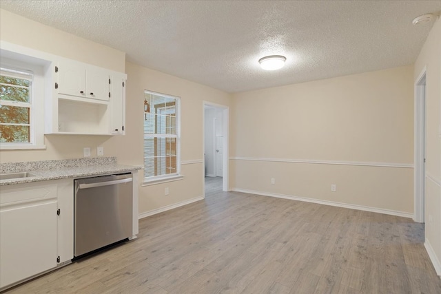 kitchen featuring stainless steel dishwasher, white cabinetry, a textured ceiling, and light wood-type flooring