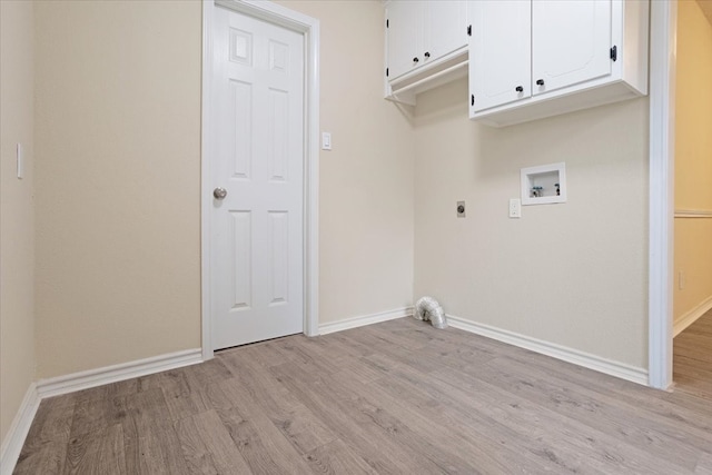 washroom featuring hookup for an electric dryer, hookup for a washing machine, light wood-type flooring, and cabinets