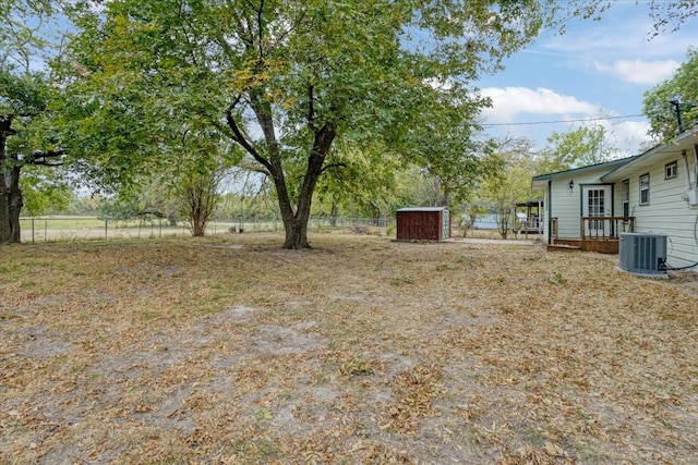 view of yard featuring cooling unit and a storage unit