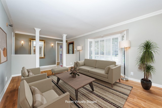 living room with ornate columns, hardwood / wood-style floors, and ornamental molding