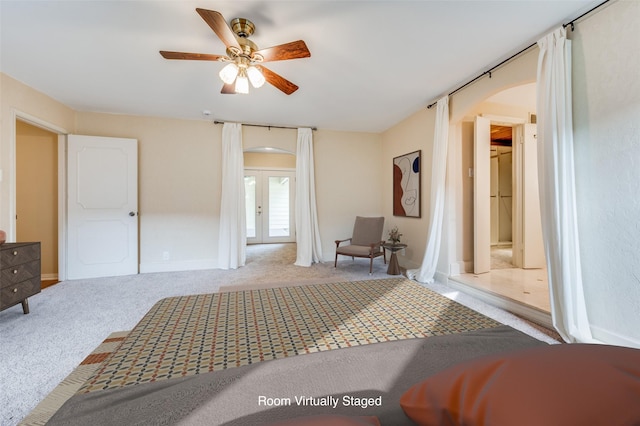 carpeted bedroom with french doors and ceiling fan