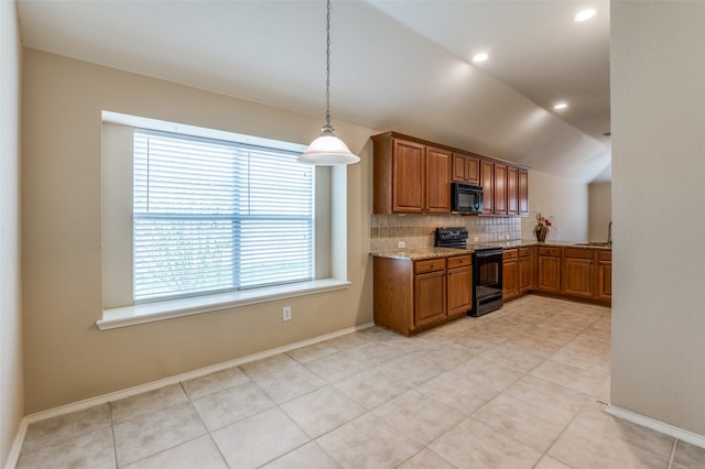 kitchen featuring vaulted ceiling, decorative light fixtures, backsplash, black appliances, and light stone countertops