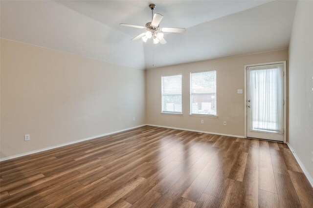 unfurnished living room with vaulted ceiling, dark hardwood / wood-style floors, and ceiling fan