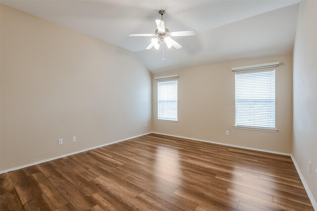 unfurnished room featuring lofted ceiling, dark hardwood / wood-style floors, and ceiling fan