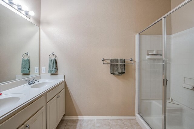 bathroom with tile patterned flooring, vanity, and an enclosed shower