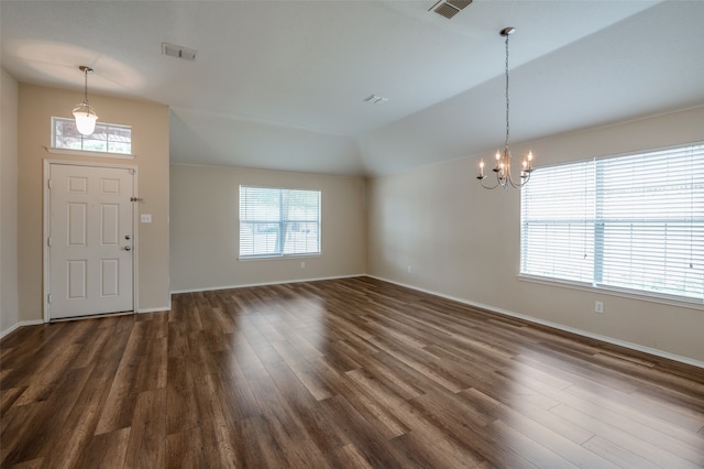 foyer entrance featuring an inviting chandelier and dark hardwood / wood-style floors