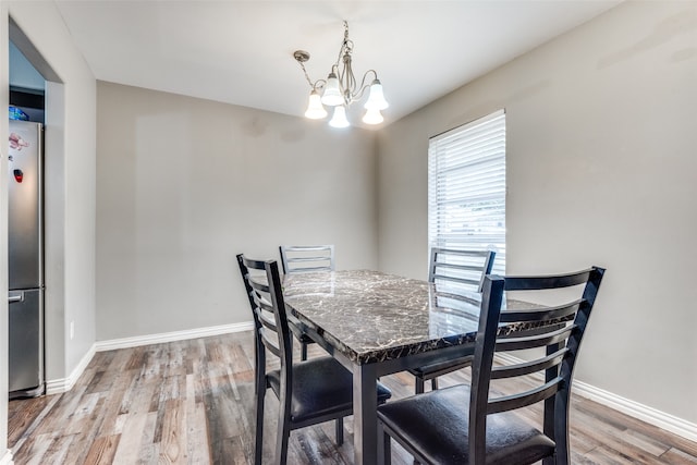 dining room with a notable chandelier and hardwood / wood-style flooring