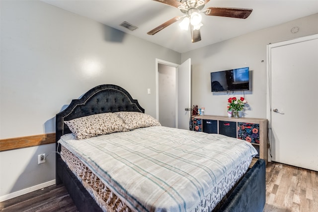 bedroom featuring ceiling fan and dark hardwood / wood-style flooring