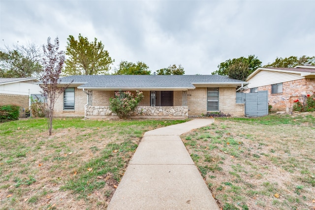 ranch-style home with a front lawn