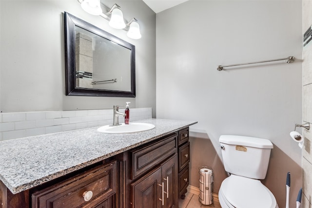 bathroom with vanity, toilet, and tile patterned flooring