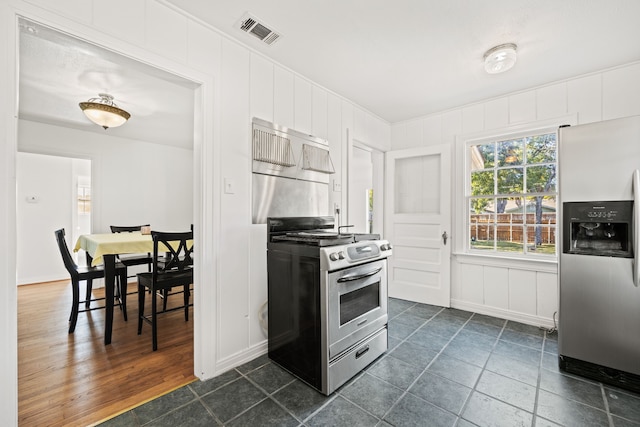 kitchen with appliances with stainless steel finishes and dark hardwood / wood-style flooring