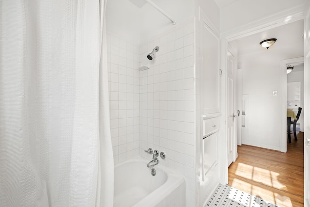 bathroom with shower / bath combo with shower curtain and wood-type flooring