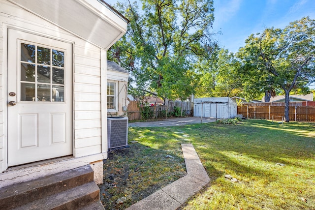 view of yard with a storage shed and central AC