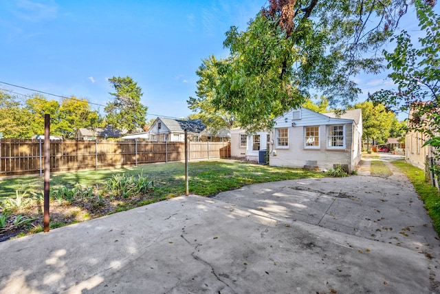 rear view of property with a patio area and a lawn