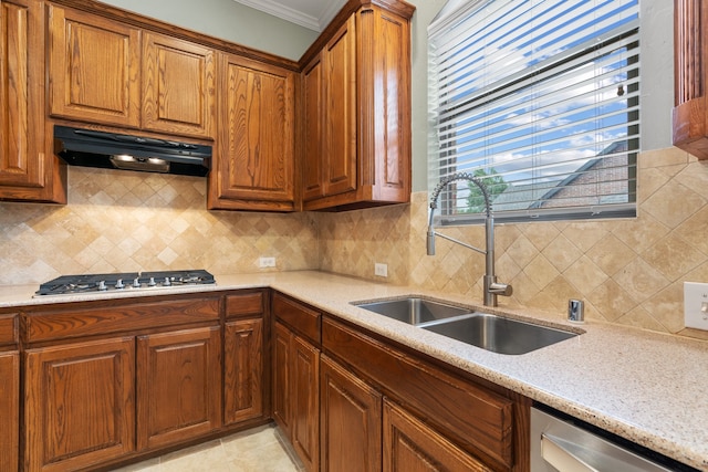 kitchen with sink, light stone counters, crown molding, decorative backsplash, and appliances with stainless steel finishes