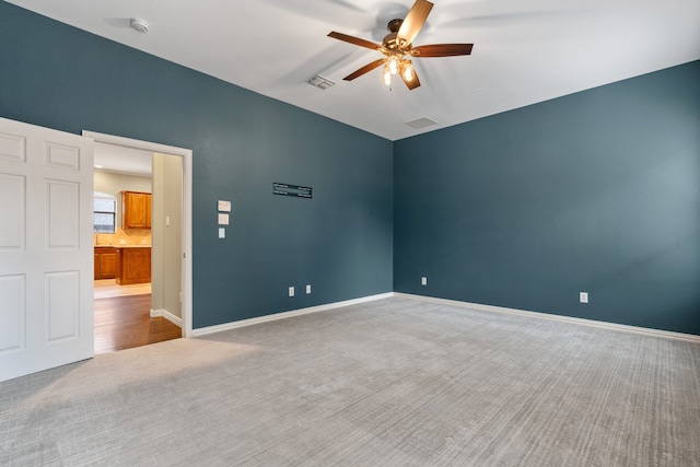 carpeted empty room with ceiling fan