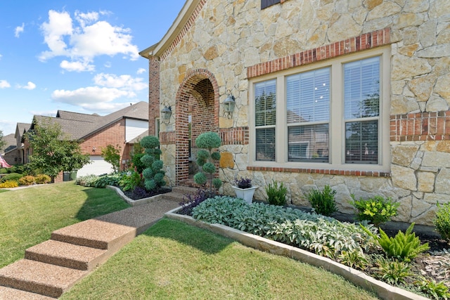 doorway to property featuring a lawn