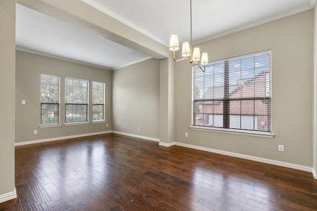 empty room featuring crown molding, dark hardwood / wood-style floors, and an inviting chandelier