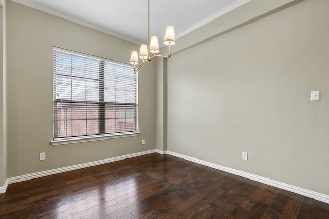 spare room with crown molding, dark hardwood / wood-style flooring, and a chandelier