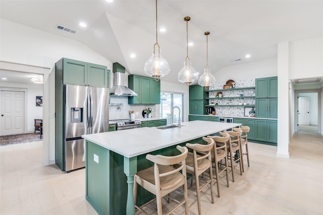 kitchen featuring decorative backsplash, a kitchen breakfast bar, wall chimney exhaust hood, stainless steel appliances, and pendant lighting