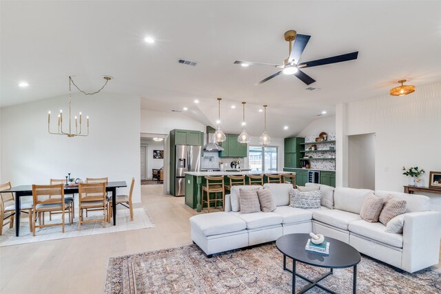 kitchen featuring pendant lighting, backsplash, a kitchen bar, stainless steel appliances, and wall chimney range hood