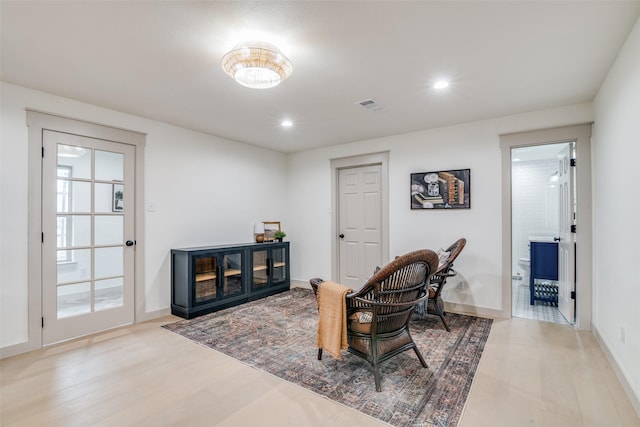 sitting room featuring light hardwood / wood-style floors