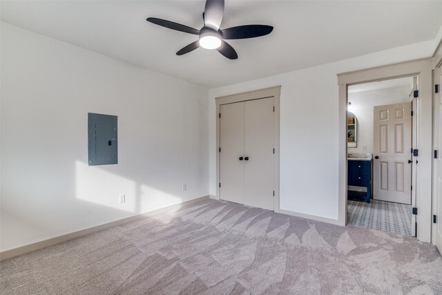 unfurnished bedroom featuring carpet floors, electric panel, ceiling fan, and a closet