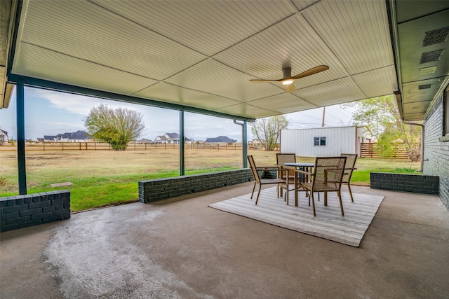 view of patio with ceiling fan, outdoor dining space, and a fenced backyard