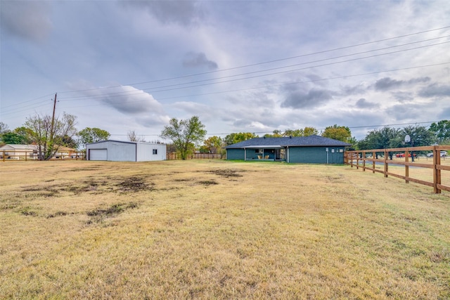 view of yard featuring fence and an outdoor structure