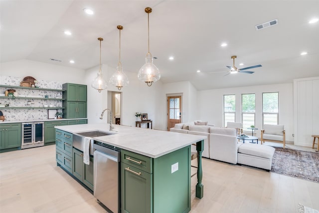 kitchen featuring beverage cooler, visible vents, dishwasher, a kitchen island with sink, and pendant lighting