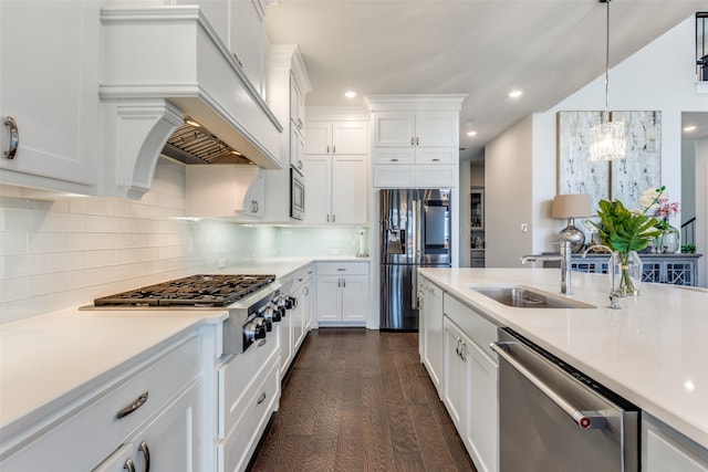 kitchen featuring decorative backsplash, white cabinets, dark hardwood / wood-style flooring, decorative light fixtures, and stainless steel appliances