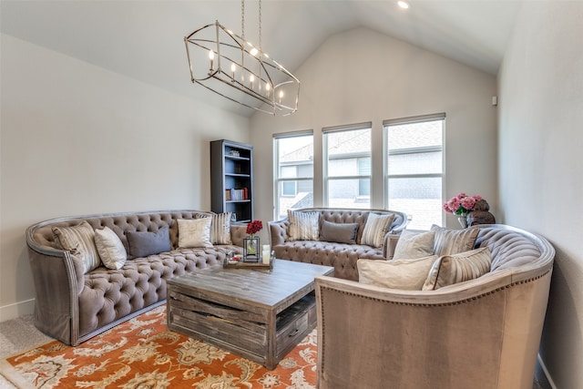 living room with a notable chandelier and high vaulted ceiling