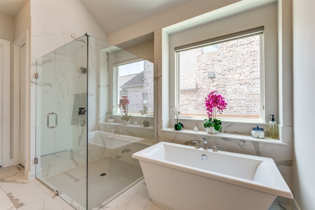 bathroom featuring vaulted ceiling, shower with separate bathtub, and a healthy amount of sunlight