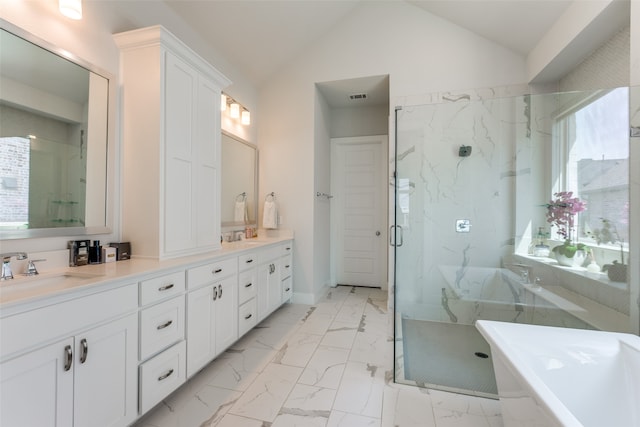 bathroom with vanity, lofted ceiling, and separate shower and tub