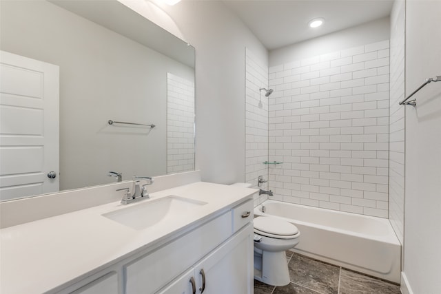 full bathroom featuring toilet, tiled shower / bath combo, and vanity