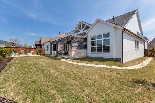 rear view of house with a patio area and a lawn