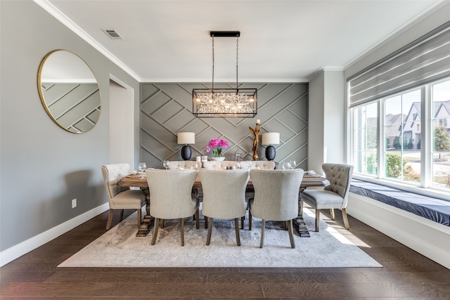 dining room featuring wooden walls, dark wood-type flooring, crown molding, and an inviting chandelier