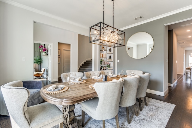 dining room with ornamental molding, a chandelier, and dark hardwood / wood-style flooring