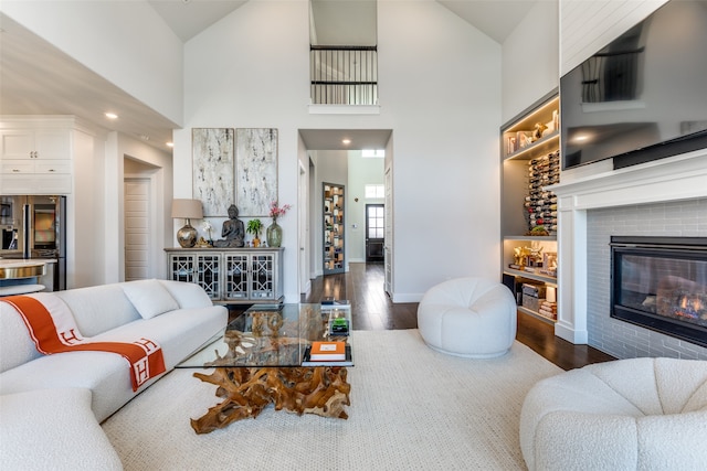 living room with dark wood-type flooring and high vaulted ceiling