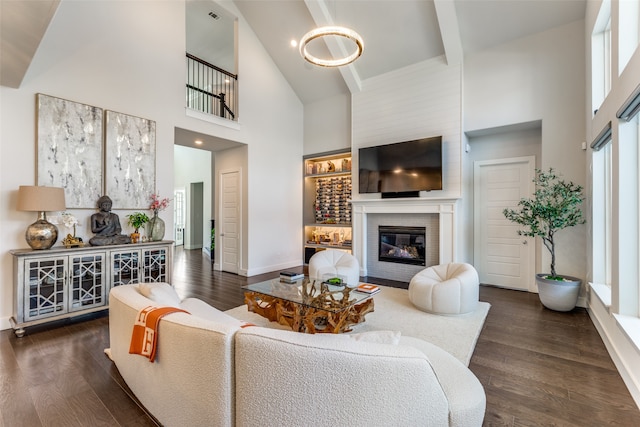 living room with beamed ceiling, a brick fireplace, dark hardwood / wood-style floors, and high vaulted ceiling