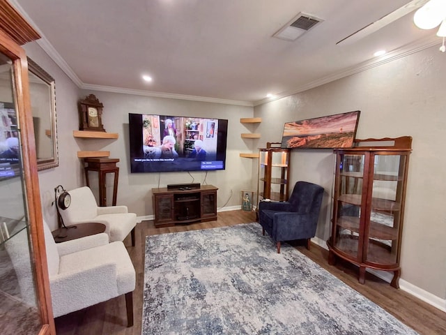 sitting room featuring crown molding and hardwood / wood-style flooring